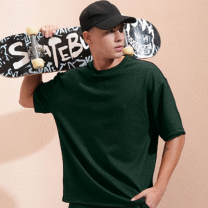 Model wearing a dark green co-ord set for men holding a skateboard, casual summer outfit.